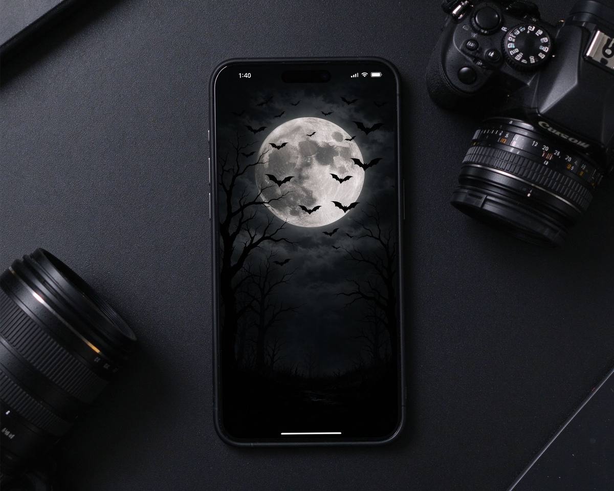 Phone screens showing spooky Halloween wallpapers: purple night sky, orange jack-o-lanterns and ghostly green moon